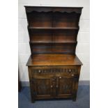 A LATE 20TH CENTURY OAK DRESSER, two plate racks above a single long drawer and two cupboard