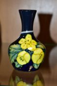 A SMALL MOORCROFT POTTERY BUD VASE, Buttercup pattern, impressed and painted backstamp, height 10.