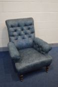 A VICTORIAN SROLLED AND BUTTON BACK ARMCHAIR in blue floral upholstery, on turned mahogany front