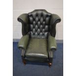 A GREEN LEATHER BUTTON BACK WINGBACK CHAIR on cabriole legs, width 90cm x depth 87cm x height