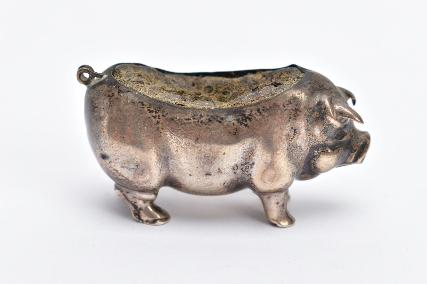 AN EDWARDIAN SILVER PIN CUSHION, in the form of a standing pig, hallmarked 'Levi & Salaman'