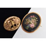 TWO VICTORIAN BROOCHES, to include a yellow metal hollow oval brooch with a foliate engraved belt