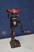 A VINTAGE IXION MANUAL DRILL PRESS overpainted in black and red paint in working order ( split to