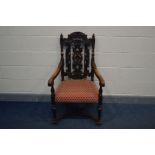 AN 20TH CENTURY OR POSSIBLY EARLIER OAK WAINSCOT CHAIR, with open arm rests and foliate