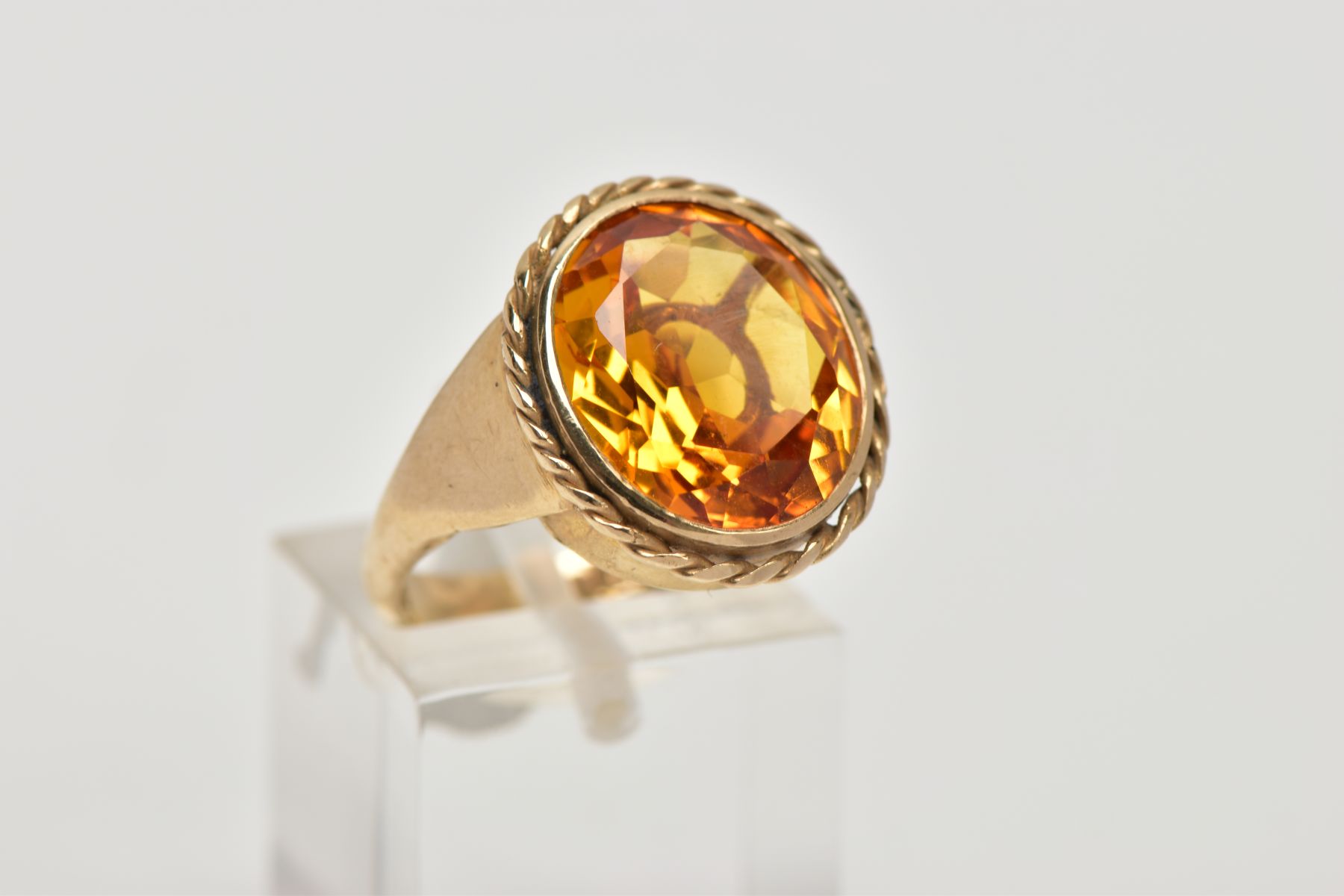 A 9CT GOLD SYNTHETIC ORANGE SAPPHIRE DRESS RING, designed with a large oval cut synthetic orange - Image 4 of 4