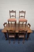 AN EDWARDIAN OAK WIND OUT DINING TABLE, with a single leaf, later fitted waiter's bell, on turned