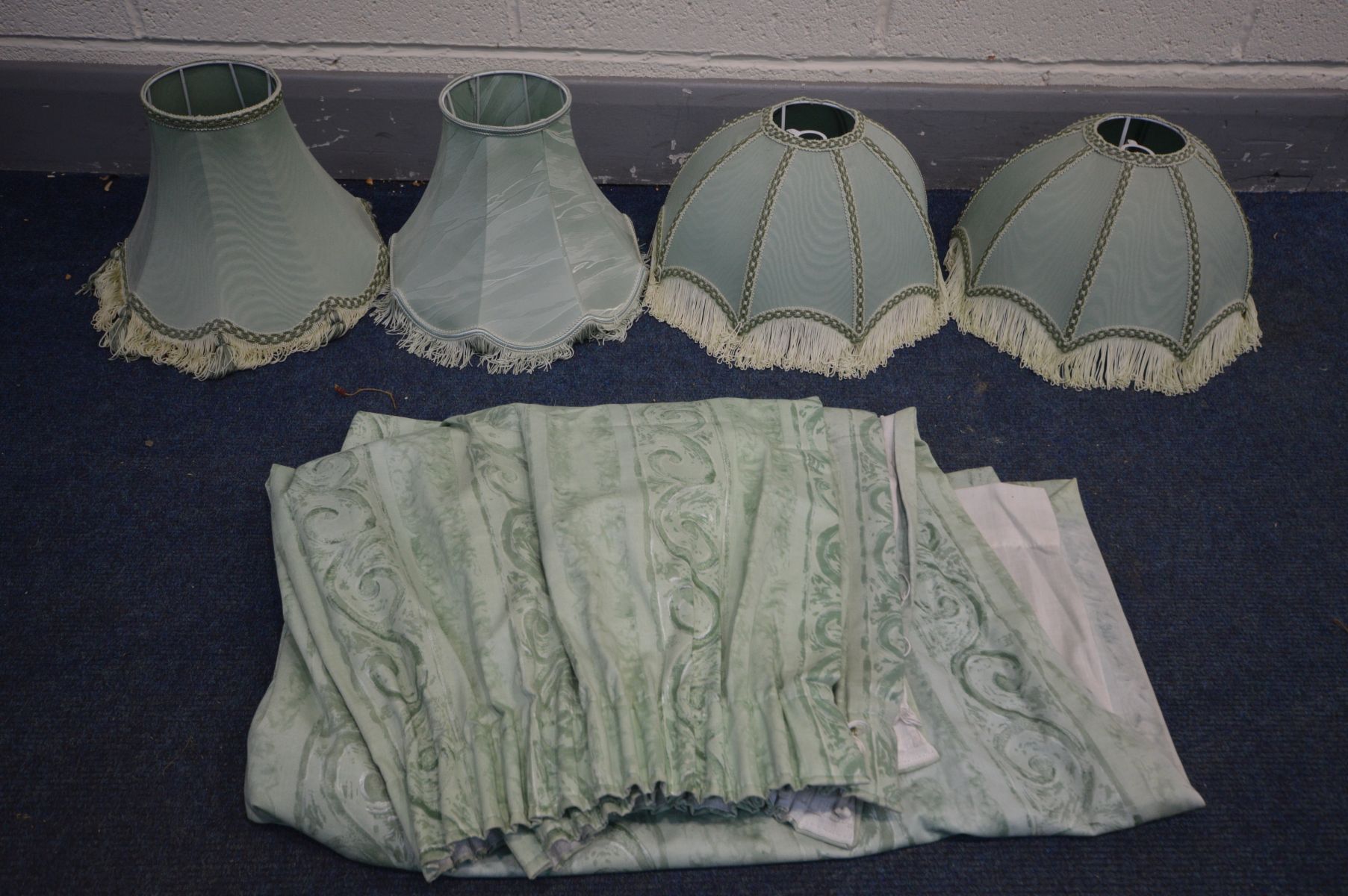 A PAIR OF GREEN DOMED TABLE LAMP SHADES, two other green shades, and a pair of green curtains (5)