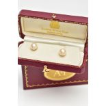 A CASED PAIR OF CULTURED PEARL EARRINGS, each set with a single cultured pearl, yellow metal post