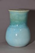 RUSKIN POTTERY, a turquoise globe and shaft vase, blue crystalline glaze to the interior,