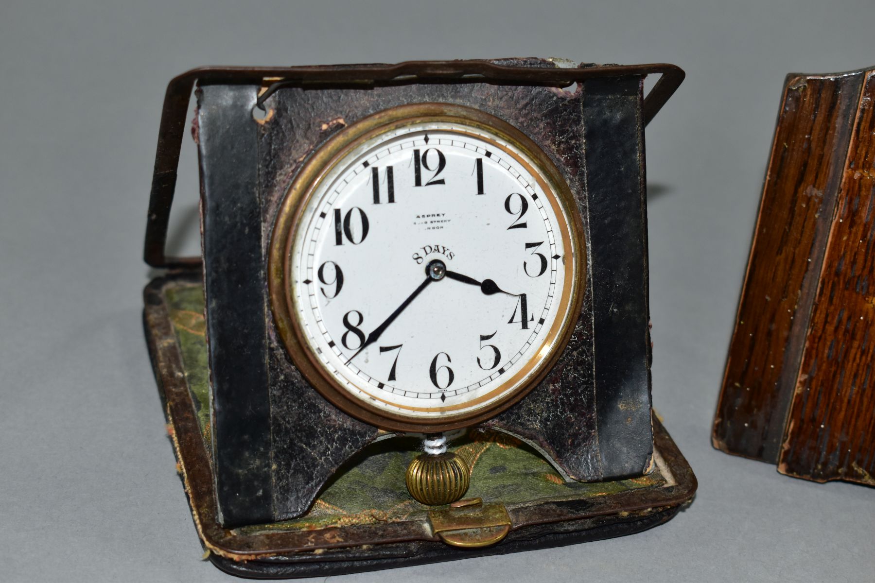 AN EARLY 20TH CENTURY ASPREY 8 DAY TRAVEL CLOCK, in a damaged leather folding case, incomplete, - Image 3 of 5