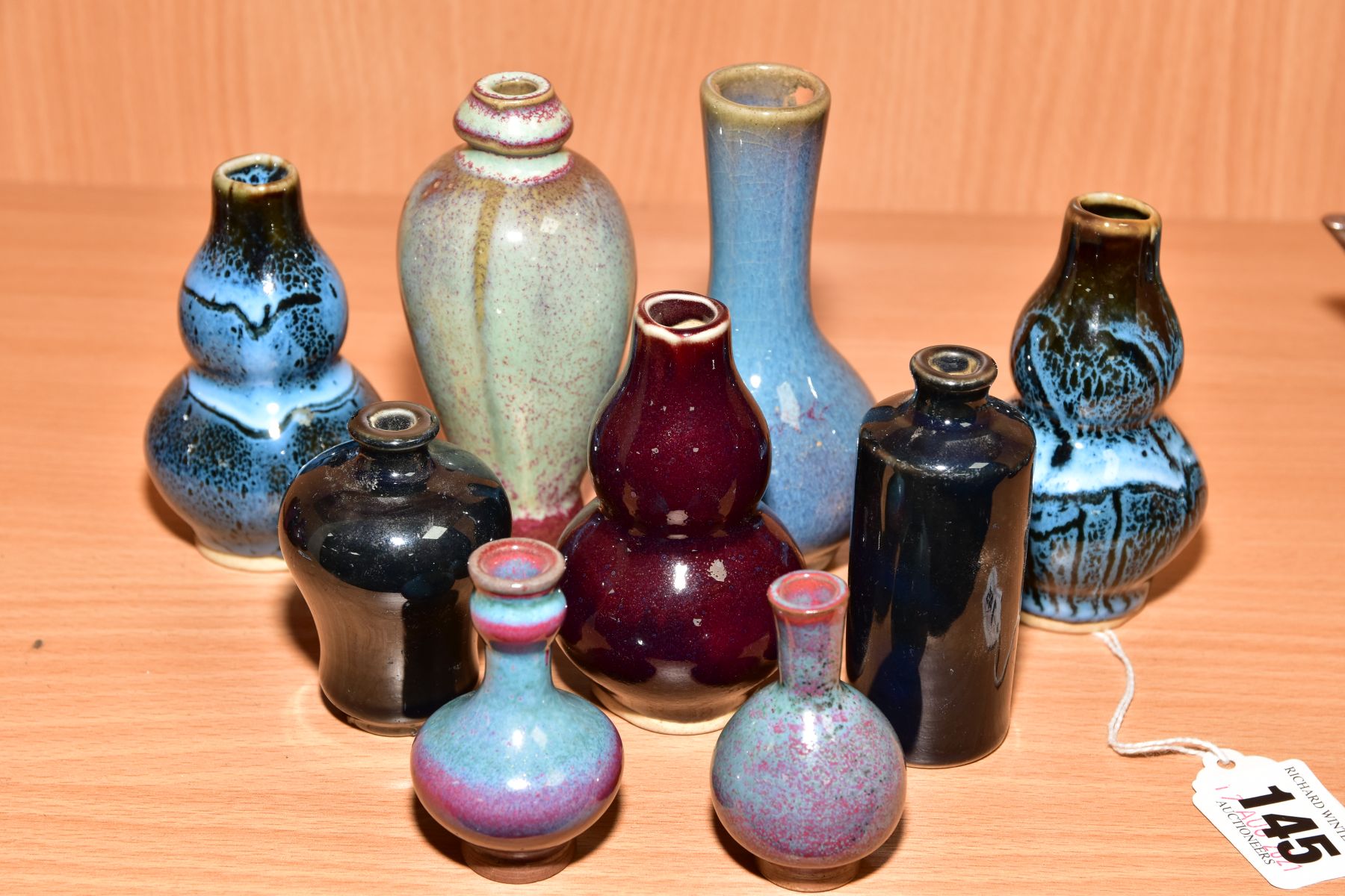 NINE MINIATURE CHINESE STYLE VASES, shapes include Meiping, double gourd and baluster, mottled,