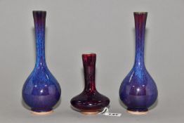 A PAIR OF PEAR SHAPED VASES WITH ELONGATED TAPERING NECKS, streaked and mottled glazes, unmarked,