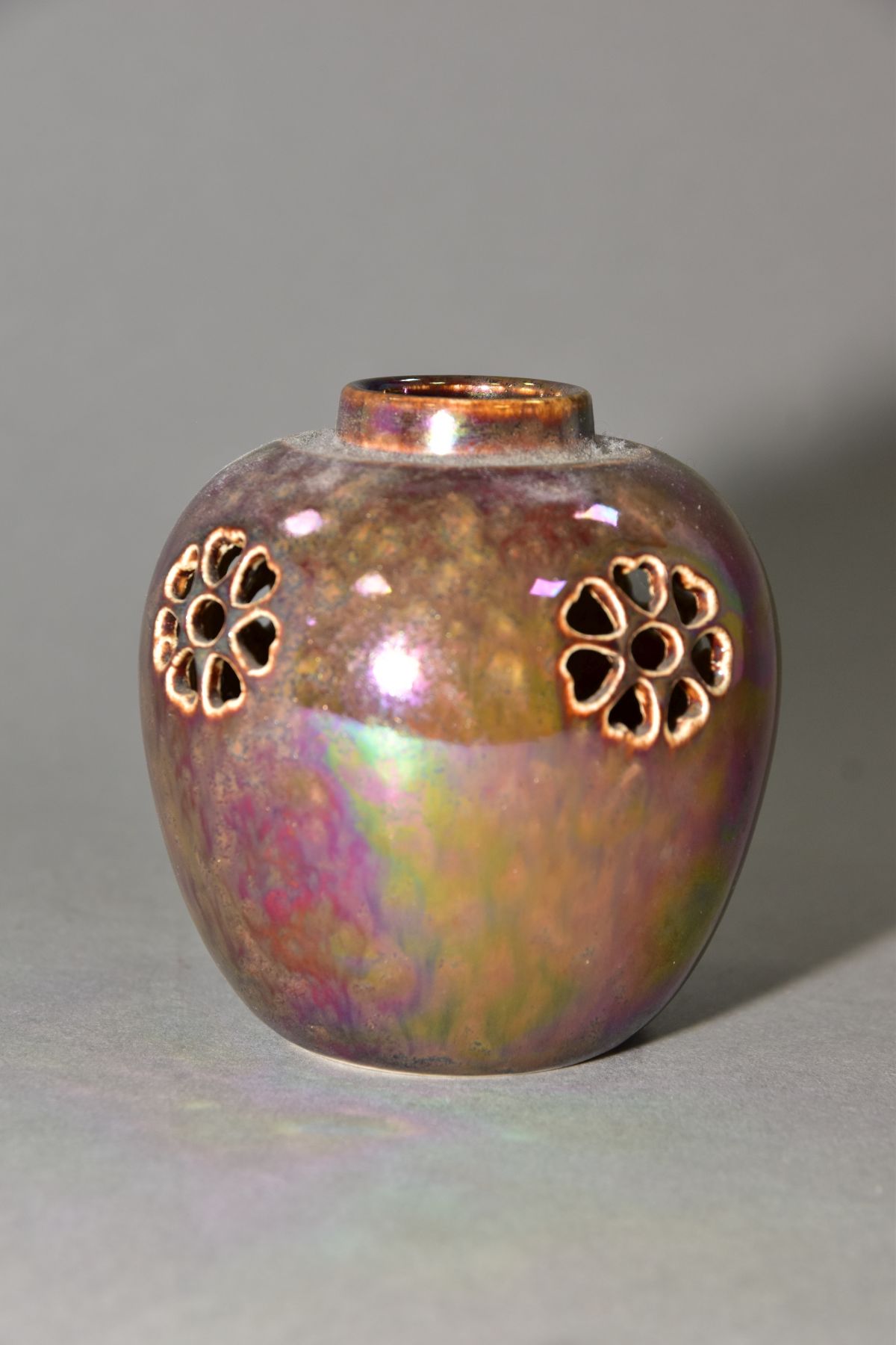 RUSKIN POTTERY, a brown lustre reticulated ginger/pot pourri jar, missing lid, the body pierced with
