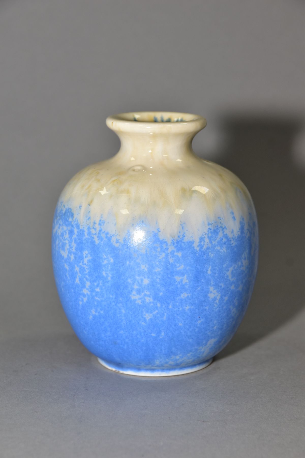 RUSKIN POTTERY, a globular vase with blue crystalline and cream glazes, impressed Ruskin England,
