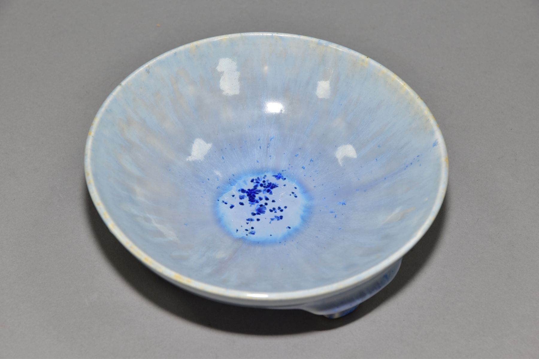 RUSKIN POTTERY, a shallow bowl raised on three feet, blue crystalline and streaked glaze, - Image 3 of 5