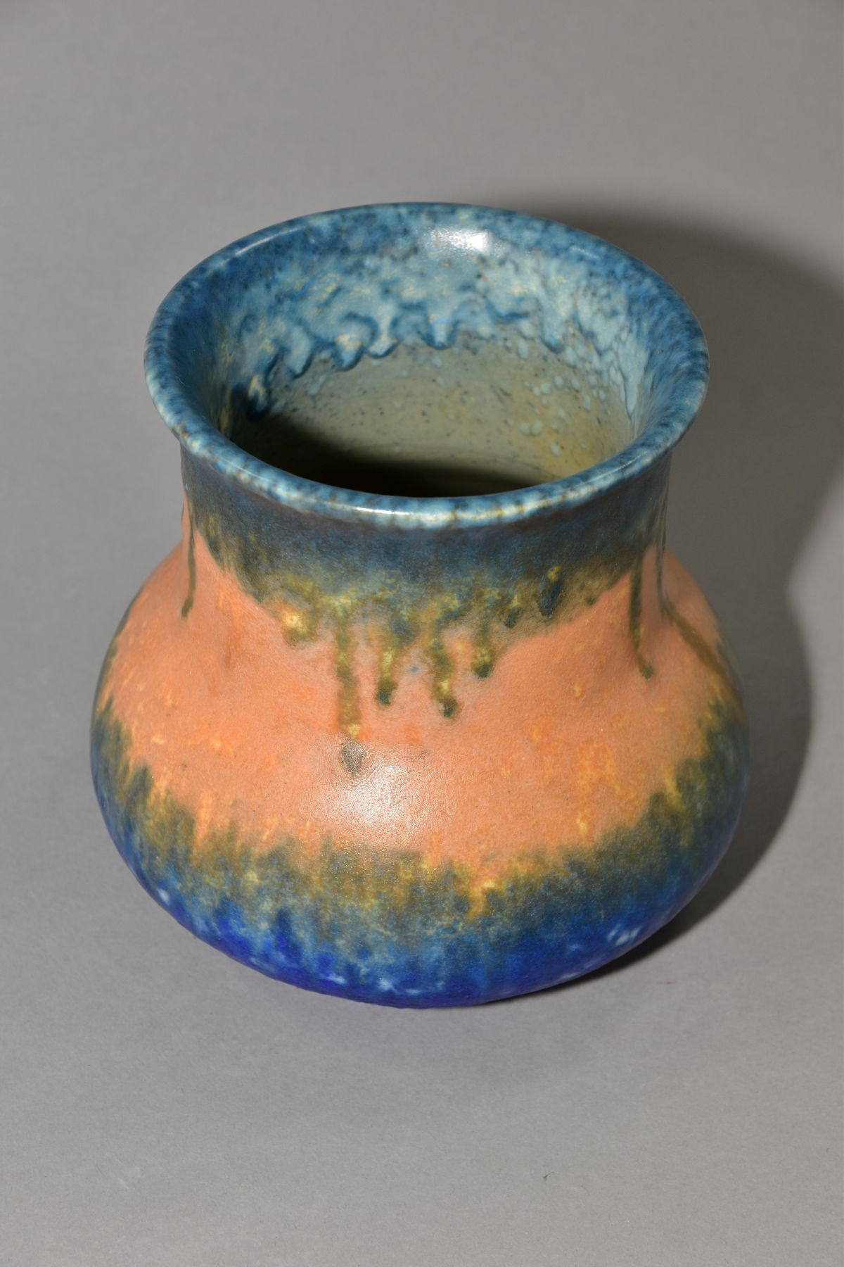RUSKIN POTTERY, an elephant's foot shaped vase, covered in bands of green, orange and blue glazes, - Image 2 of 4