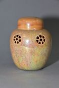 RUSKIN POTTERY, a peach lustre reticulated ginger/pot pourri jar with cover, the body pierced with