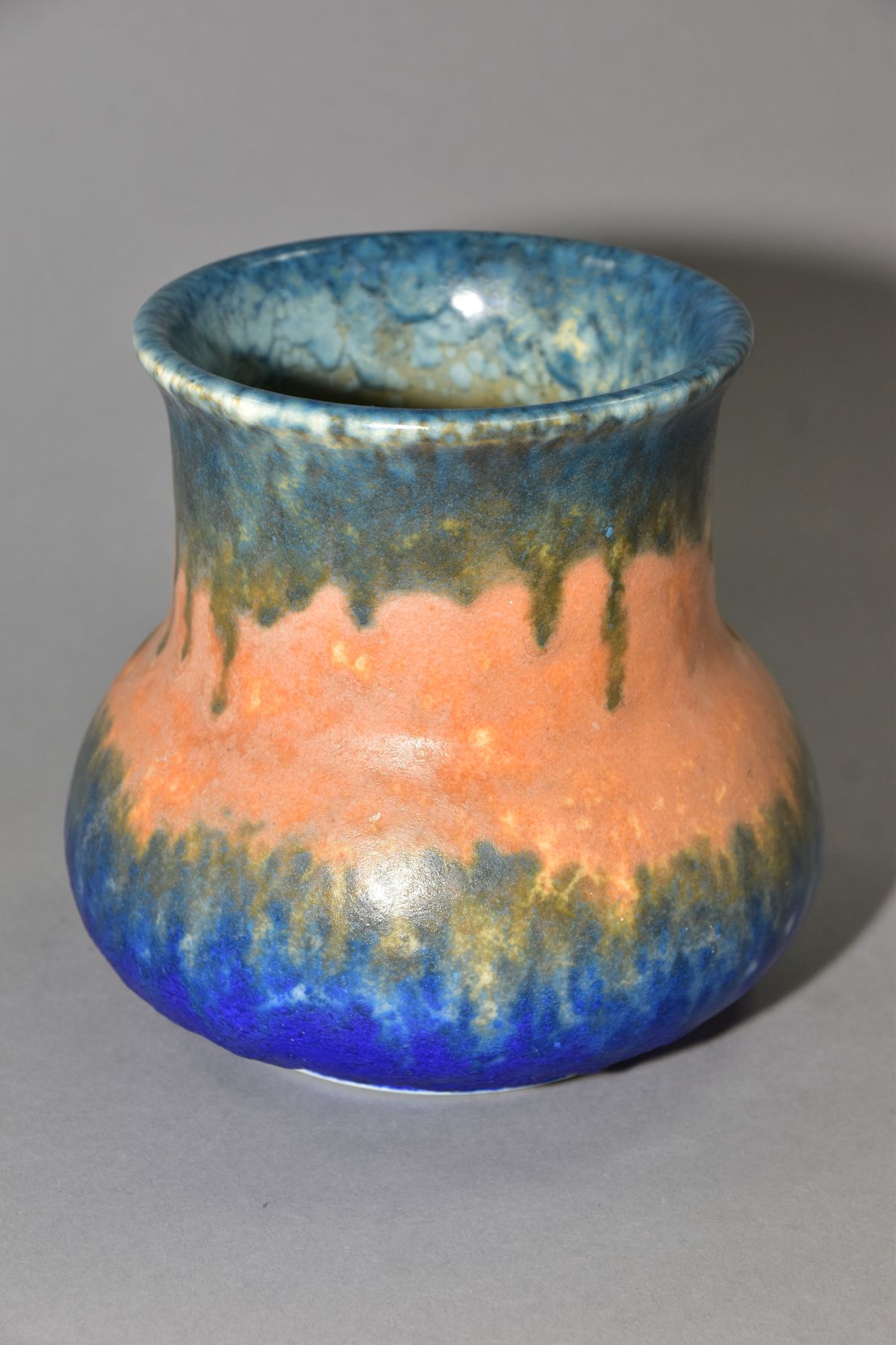 RUSKIN POTTERY, an elephant's foot shaped vase, covered in bands of green, orange and blue glazes, - Image 3 of 4