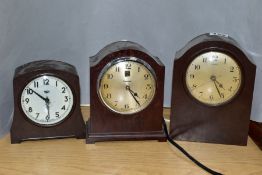 THREE BROWN BAKELITE CASED ELECTRIC MANTEL CLOCKS, comprising a Ferranti, height 17.5cm, a Genolex