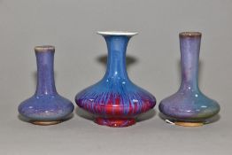 THREE COMPRESSED PEAR SHAPED VASES, one having a flared rim with crackle glaze, red and purple