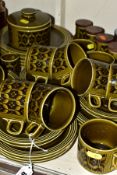 A QUANTITY OF HORNSEA HEIRLOOM PATTERN GREEN GLAZED WARES, including a wooden rack fitted with six