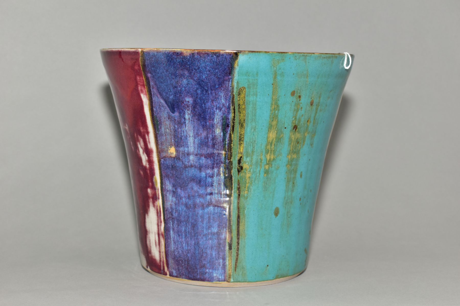 A DARTINGTON POTTERY CONICAL JARDINIERE, decorated with wide vertical bands of turquoise, blue and