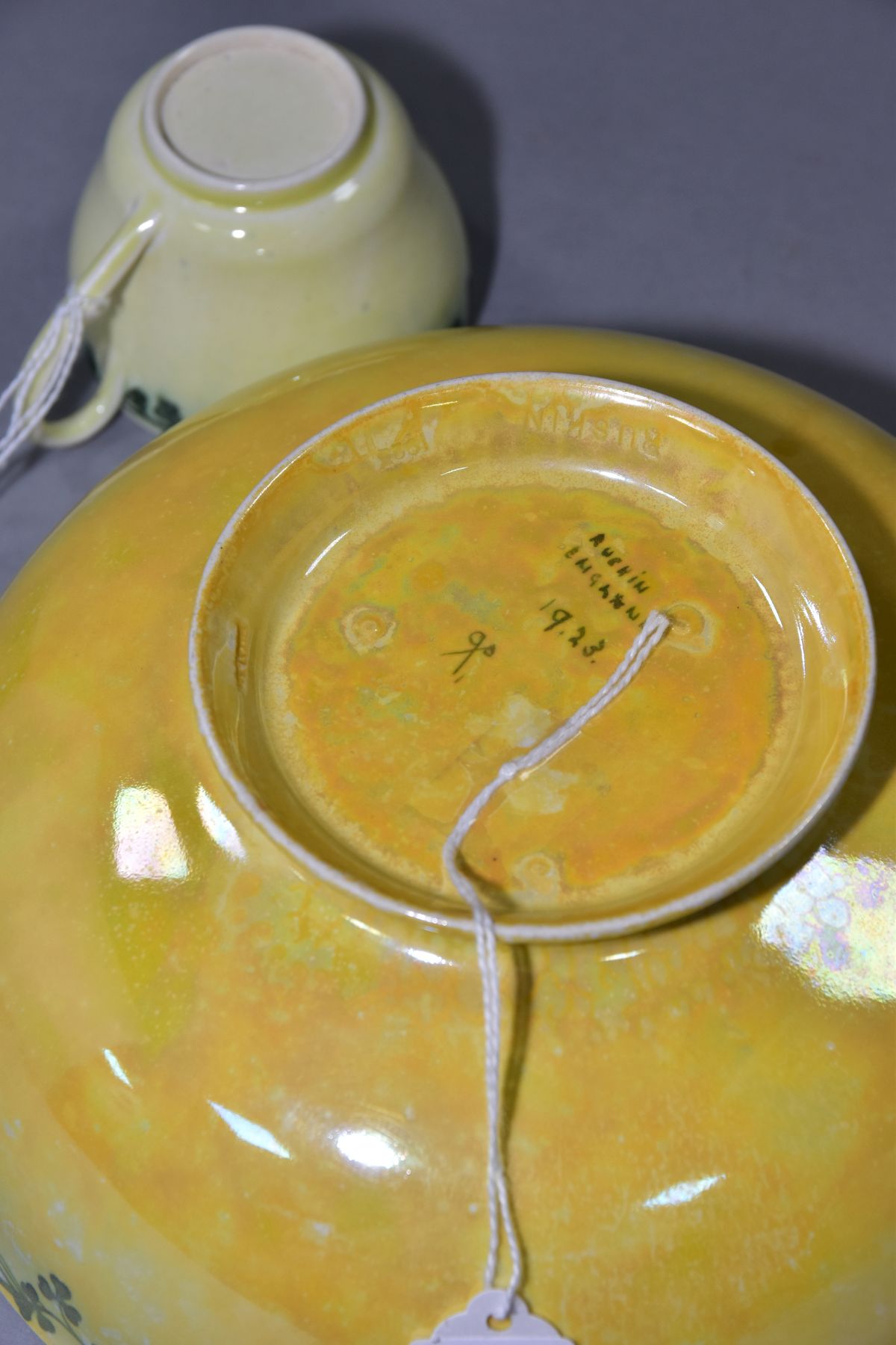 RUSKIN POTTERY, a footed eggshell bowl, covered in a yellow glaze with a band of clover to the outer - Image 4 of 5