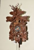 A SECOND HALF 20TH CENTURY WOODEN CUCKOO CLOCK, the case carved with gabled roof, Stag's head, hare,