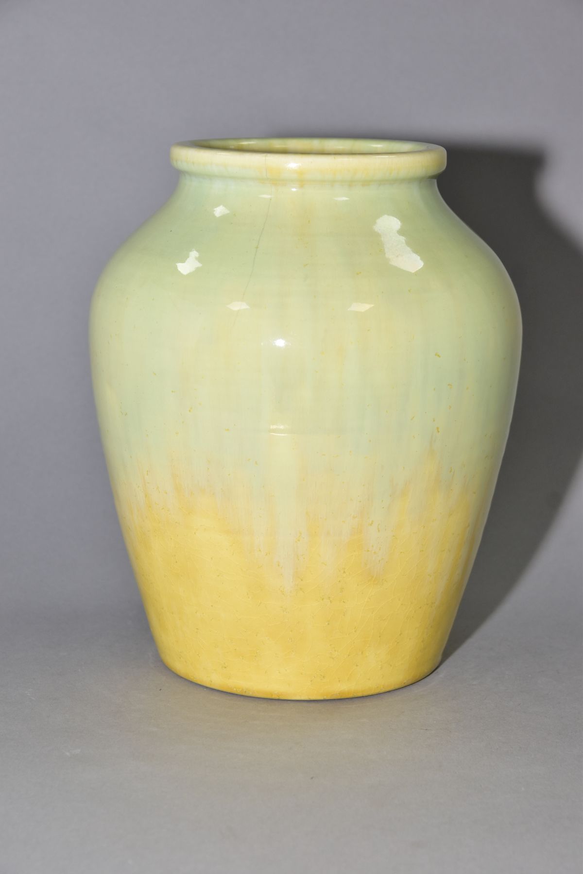 RUSKIN POTTERY, a pale green and yellow lustre baluster vase, impressed Ruskin England to the