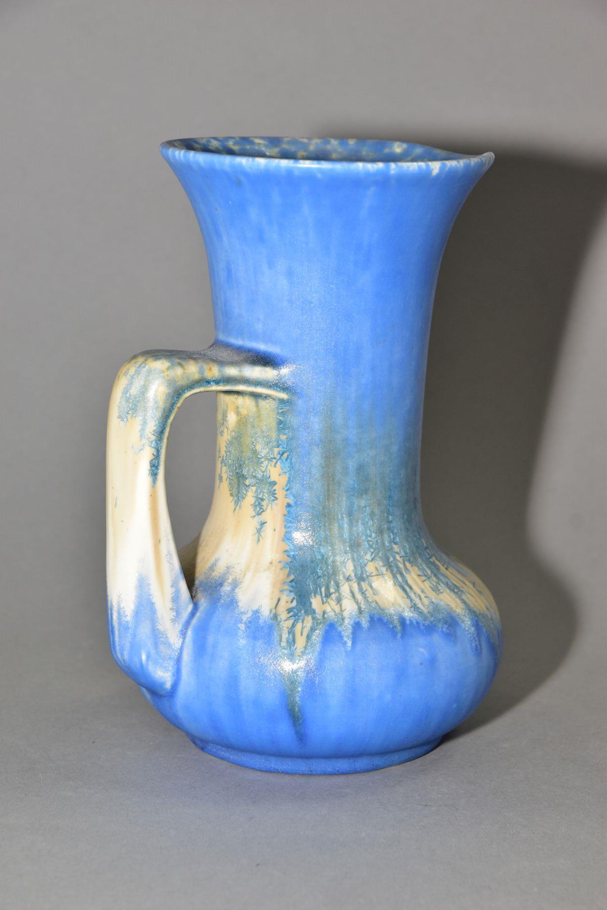 RUSKIN POTTERY, a water jug of onion form, covered in blue crystalline white and cream glazes,