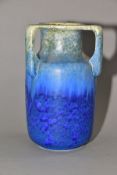 RUSKIN POTTERY, a three handled bottle shaped vase, mottled green fading to blue glaze, inscribed W.