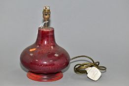 A COBRIDGE STONEWARE BULBOUS TABLE LAMP, sang de bouef glaze, mounted on a wooden plinth, height