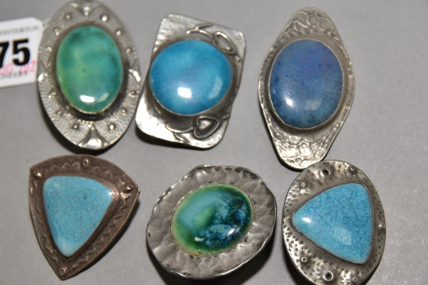 SIX RUSKIN STYLE BROOCHES, five enamels set into pewter, one stamped FTG hand wrought, one enamel - Image 2 of 3