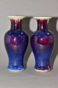 A PAIR OF BALUSTER VASES covered in high fired Ruskin style glazes, unmarked, approximate height