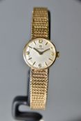 A 9CT GOLD HAND WOUND LADIES OMEGA WRISTWATCH, silvered dial with gold baton markers and quarterly