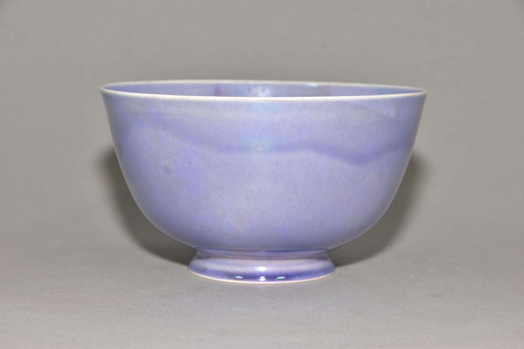 RUSKIN POTTERY, a footed eggshell bowl, covered in a lavender lustre glaze, impressed Ruskin England