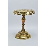 A VICTORIAN BRASS TRIVET, circular pierced top, knopped stem, stepped circular weighted base,