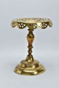 A VICTORIAN BRASS TRIVET, circular pierced top, knopped stem, stepped circular weighted base,