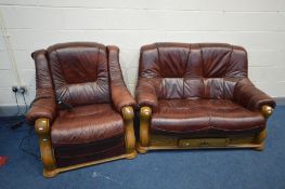 AN OAK FRAMED AND BURGANDY LEATHER TWO PIECE LOUNGE SUITE, comprising a sofa and an electric