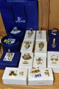 A COLLECTION OF FOURTEEN BOXED SWAROVSKI CRYSTAL MINIATURE ITEMS, comprising nine Crystal Memories