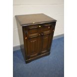A REPRODUCTION WALNUT MEDIA CABINET, with a fold over lid enclosing a pull out slide, width 96cm x