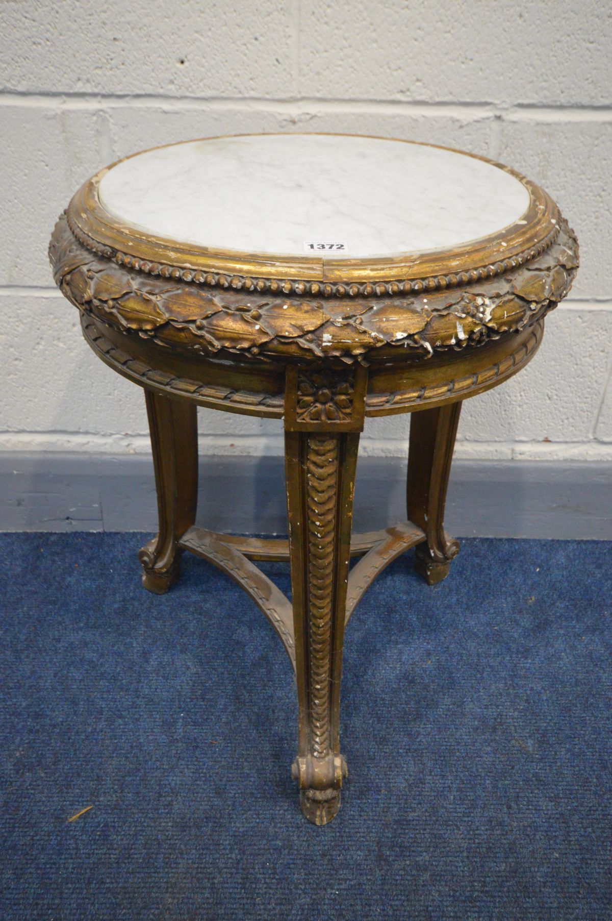 A FRENCH GILTWOOD CIRCULAR MARBLE TOP OCCASIONAL TABLE, on triple legs united by a shaped stretcher,