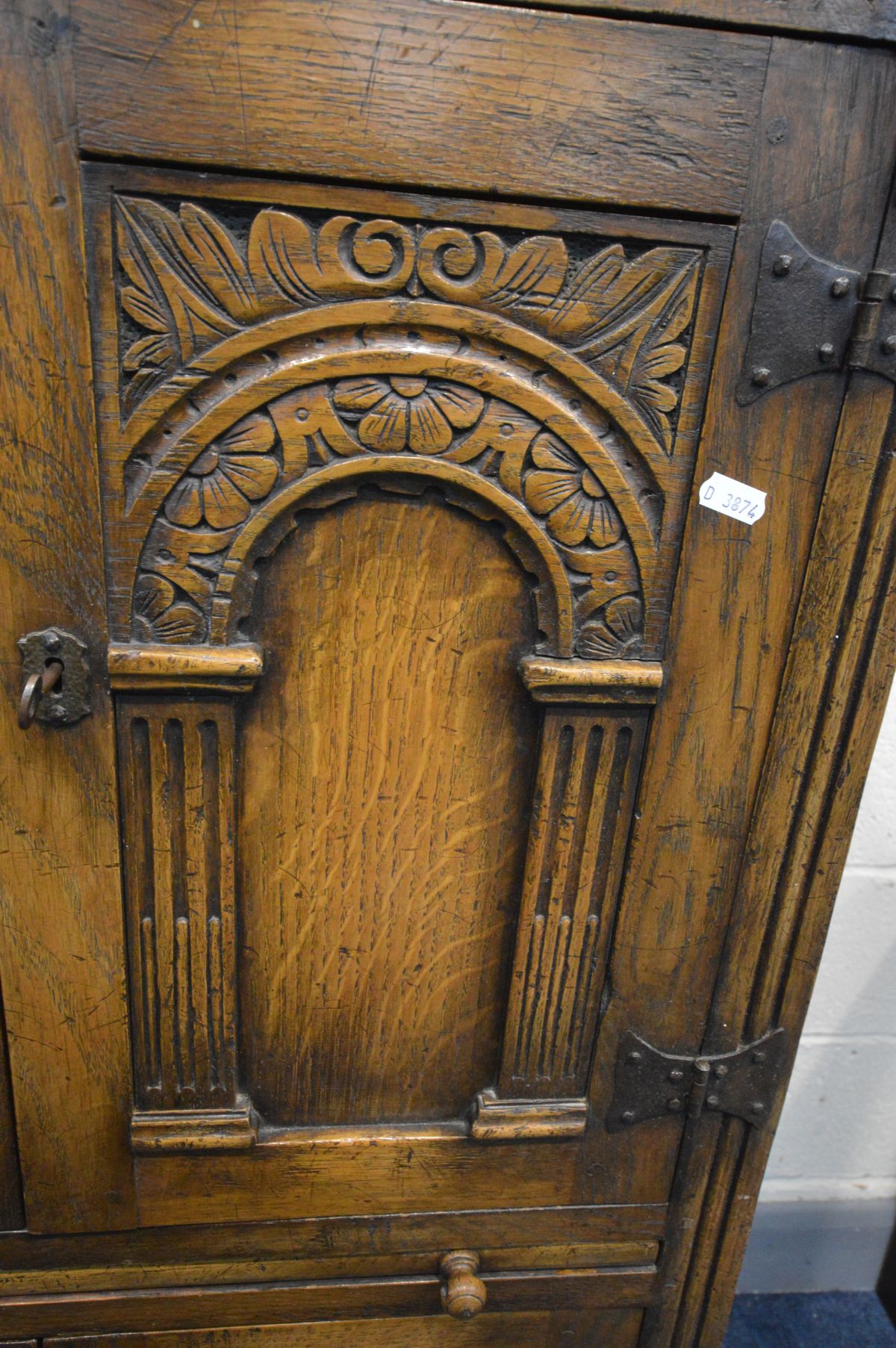 A REPRODUCTION OAK FOUR DOOR DRINKS CABINET, the arched panel door enclosing an arched shelf, and - Image 3 of 8