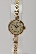A LADIES 9CT GOLD TUDOR WRISTWATCH, hand wound movement, round champagne dial signed 'Tudor', Arabic