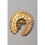 A LATE VICTORIAN 9CT GOLD HORSESHOE BROOCH, with scalloped and beaded edge detail, applied floral