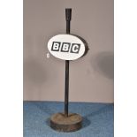 A 'BBC' SIGN, on a cast iron stand and circular base, height 109cm