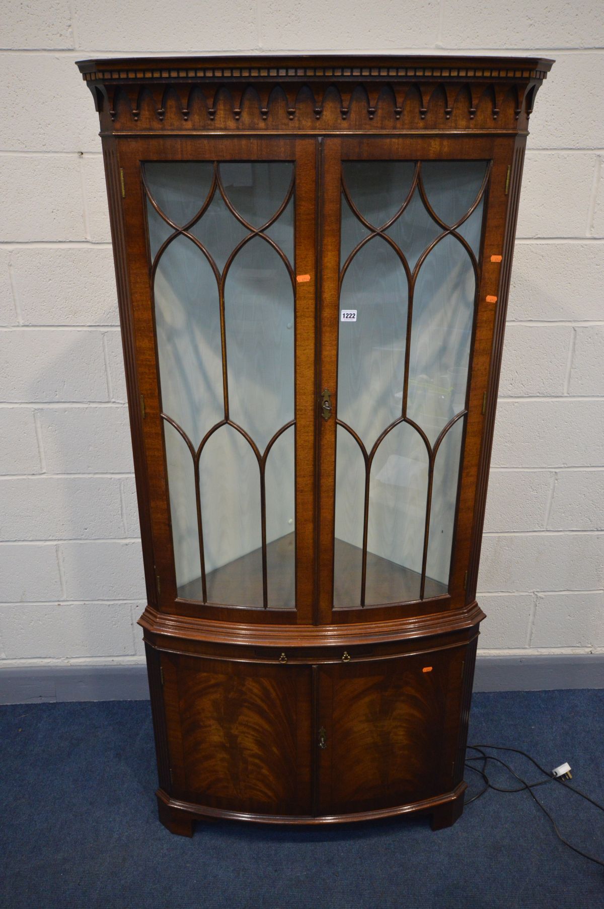 A REPRODUX MAHOGANY DOUBLE DOOR BOWFRONT CORNER CUPBOARD, two glass adjustable shelves, brushing