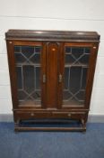 AN EARLY TO MID 20TH CENTURY OAK LEAD GLAZED TWO DOOR BOOKCASE, with two drawers, width 104cm x