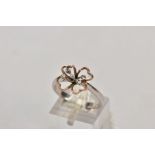 A 9CT WHITE GOLD DIAMOND RING, an AF bi-colour openwork flower design, set with small round