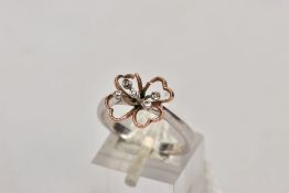 A 9CT WHITE GOLD DIAMOND RING, an AF bi-colour openwork flower design, set with small round